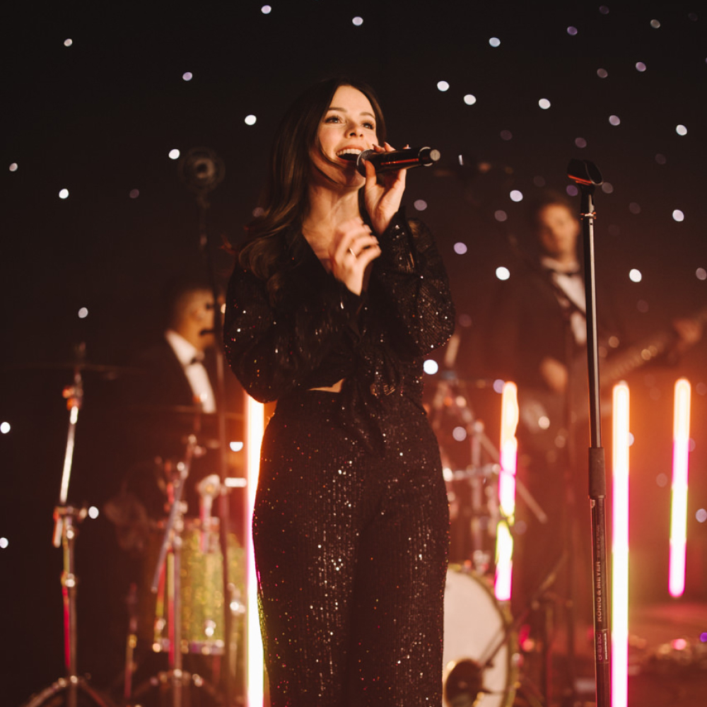 One of our singers Grace Walker performing in front of slick LED lights